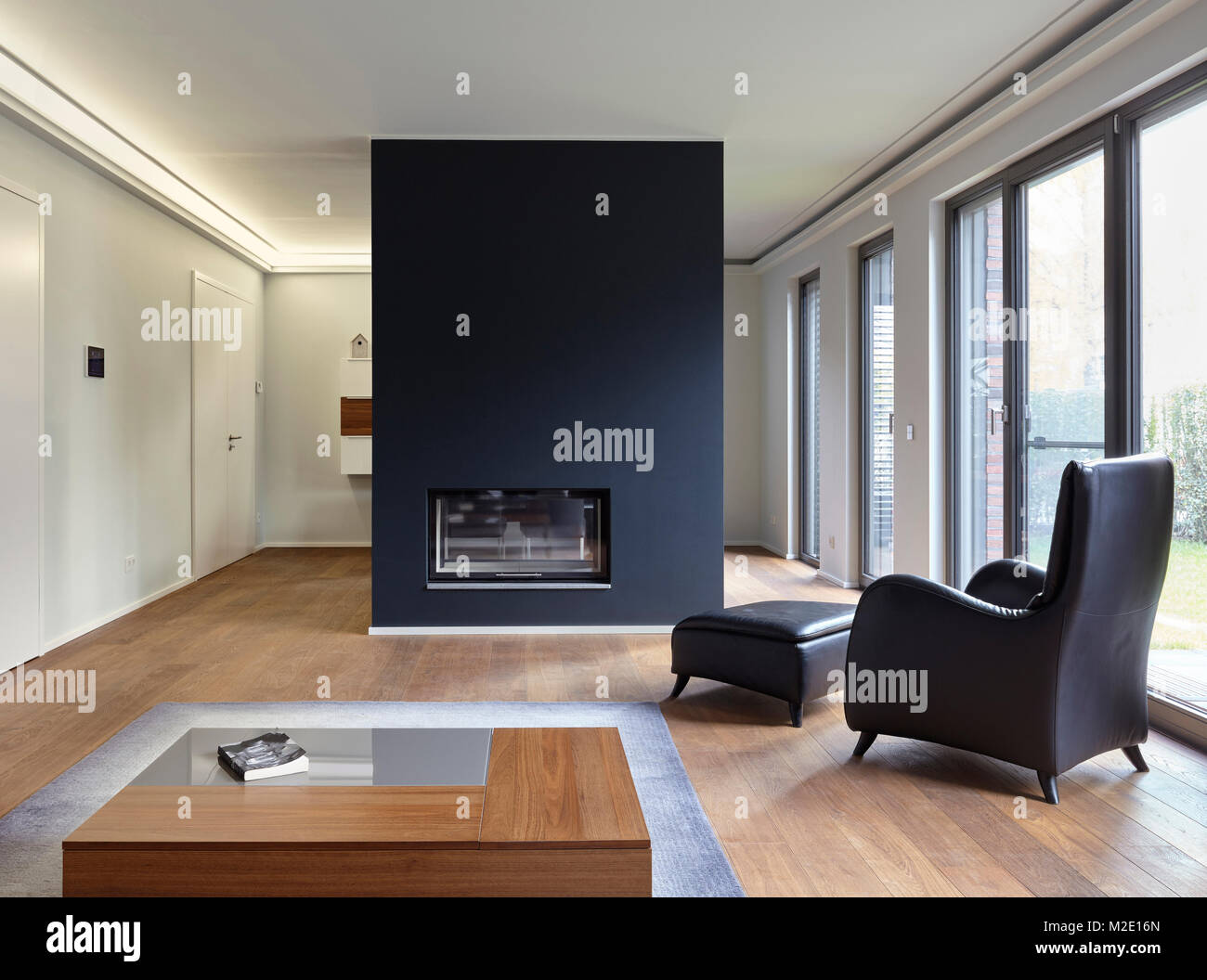 Plank floor and modern fireplace in home Stock Photo