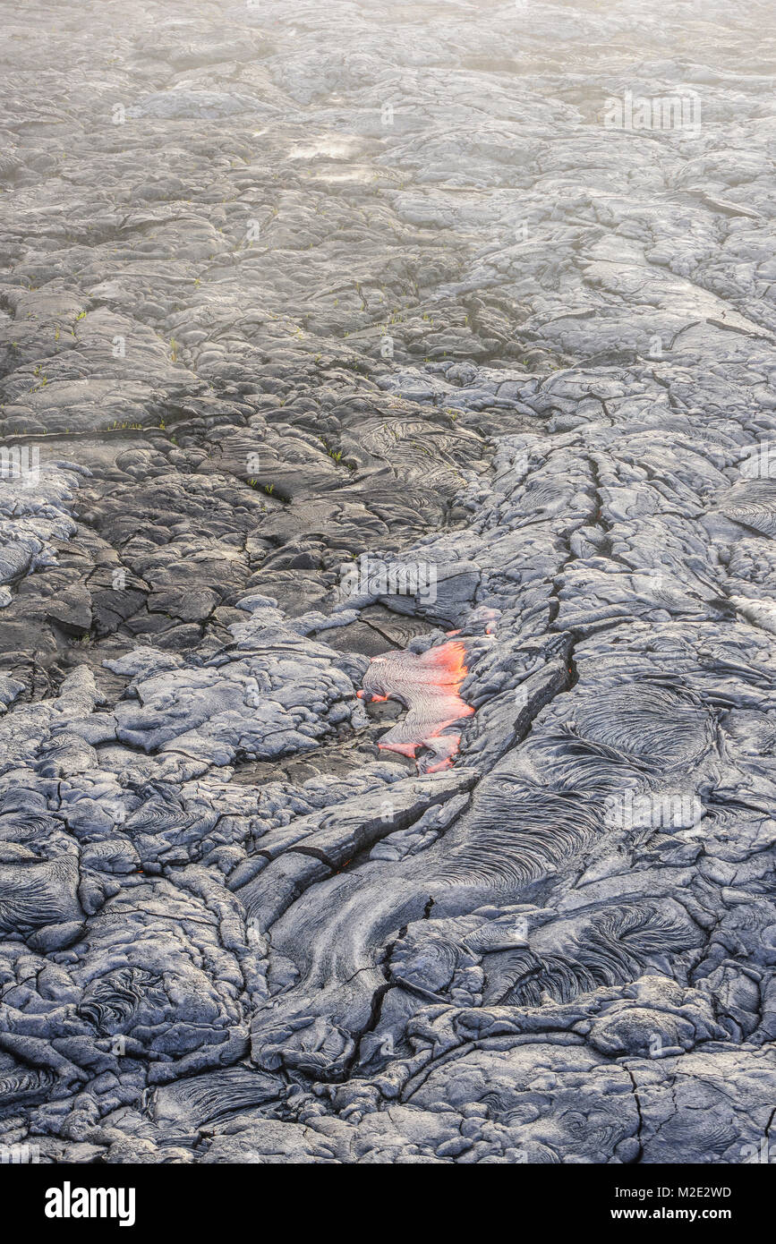 Molten lava glowing near dried lava Stock Photo