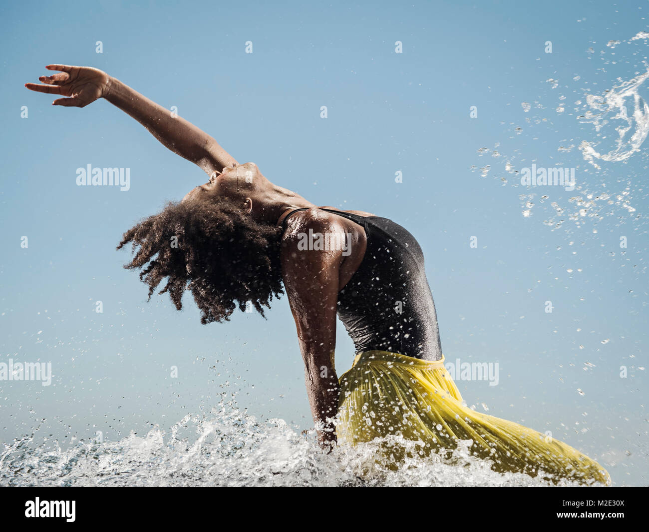 Black woman dancing in water Stock Photo
