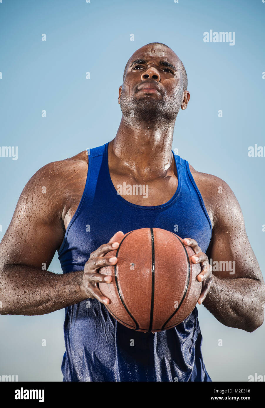 Pensive sweating Black man holding basketball Stock Photo