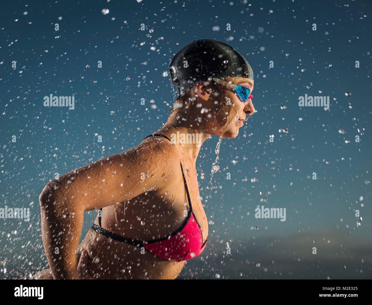 Water splashing on Caucasian swimmer Stock Photo
