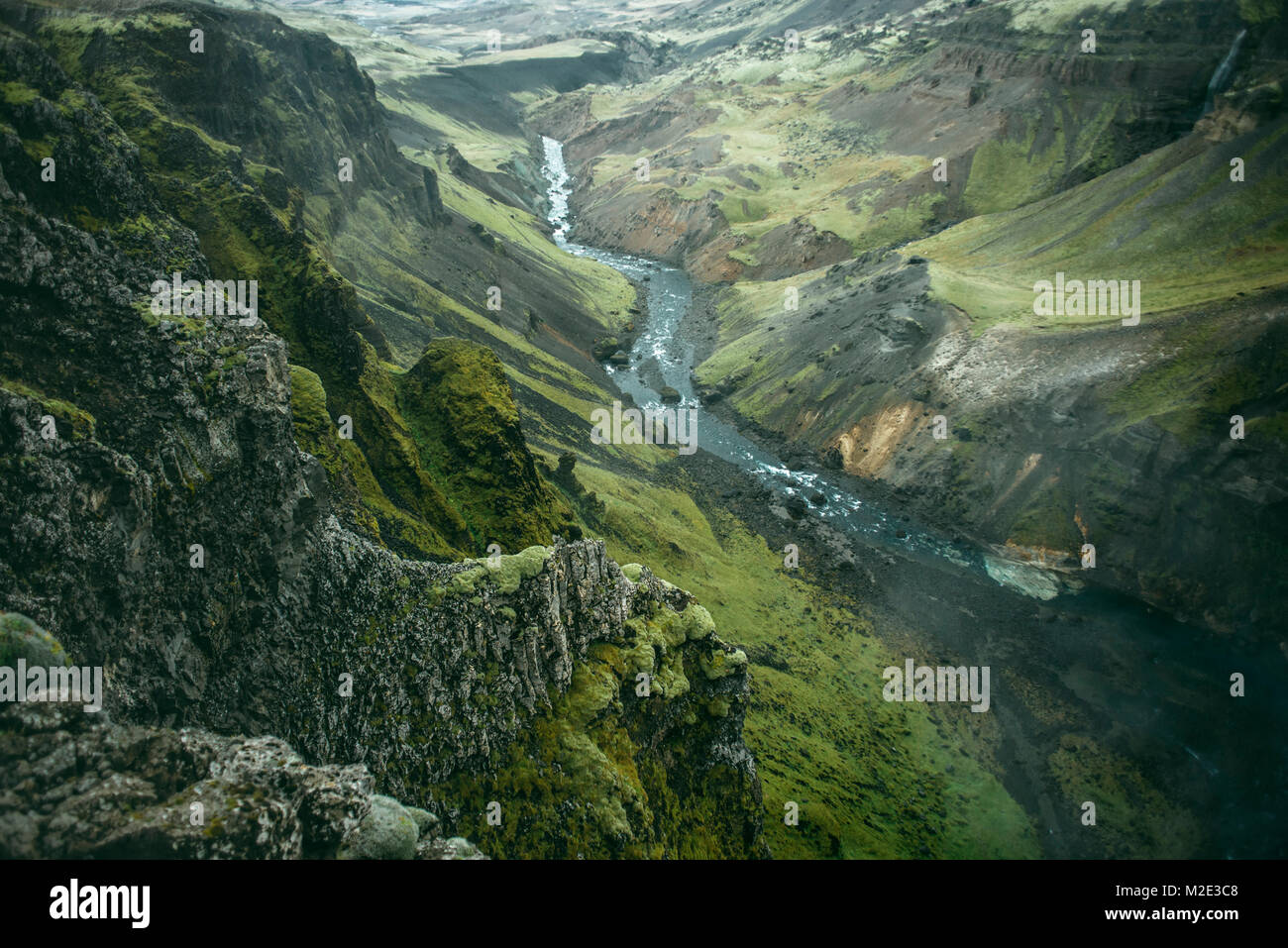 Scenic view of river in green valley Stock Photo