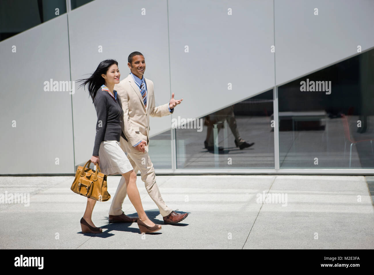 Business people walking and talking outdoors Stock Photo - Alamy