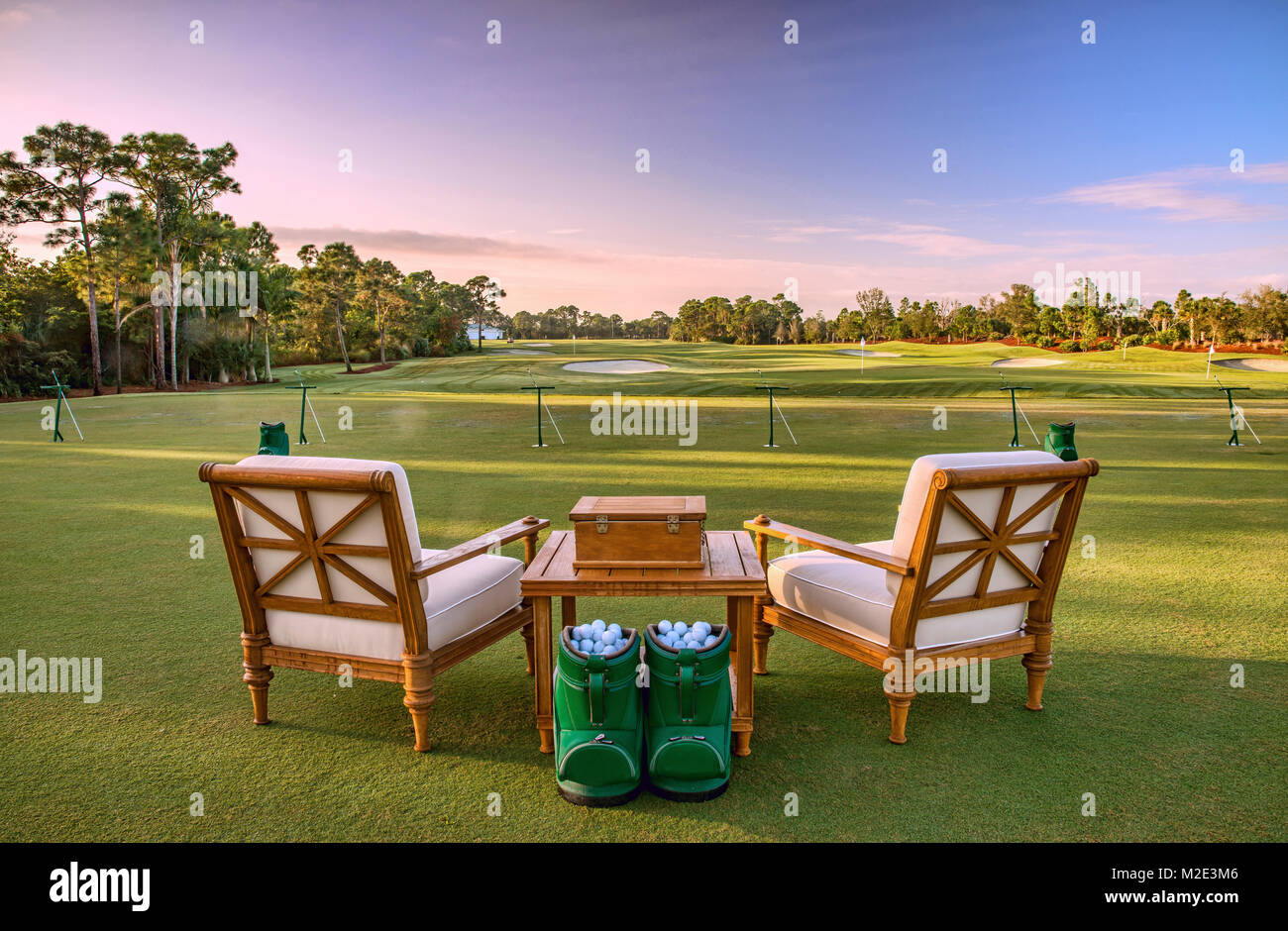 Chairs and golf balls on driving range Stock Photo