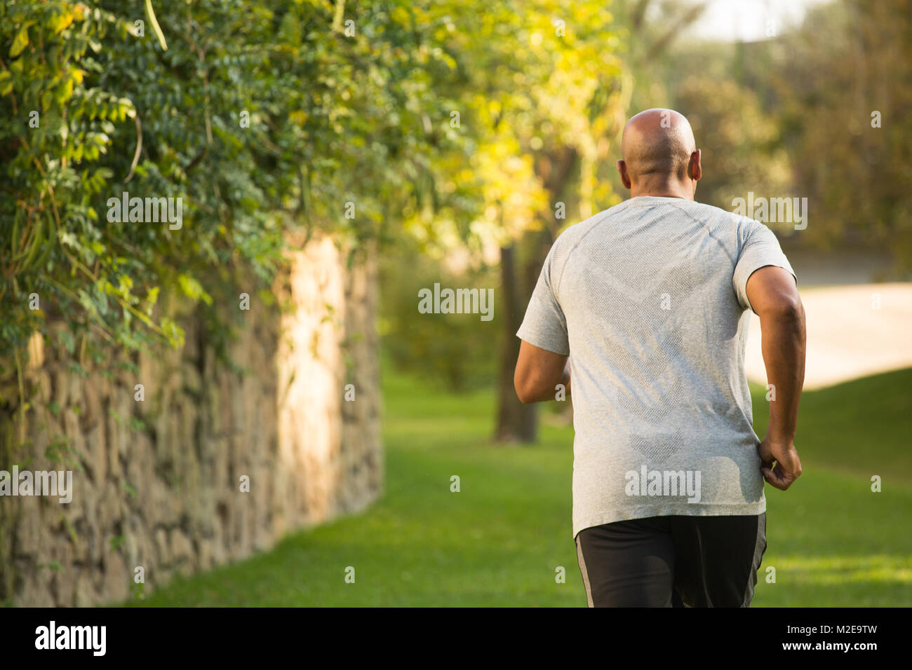 Fit African American man running. Stock Photo