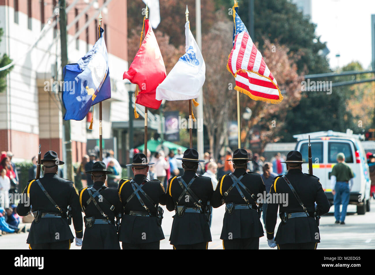 A color guard of six uniformed men presents the colors while walking in the Georgia Veterans Day Parade on November 11, 2017 in Atlanta, GA. Stock Photo
