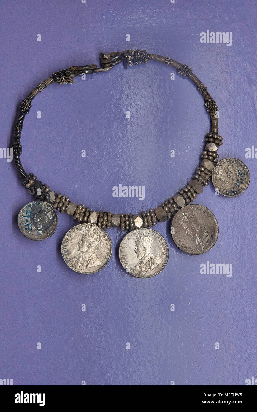 Necklace made from British era currency coins. Coins depicting King emperor George V. The necklace has silver beads Stock Photo
