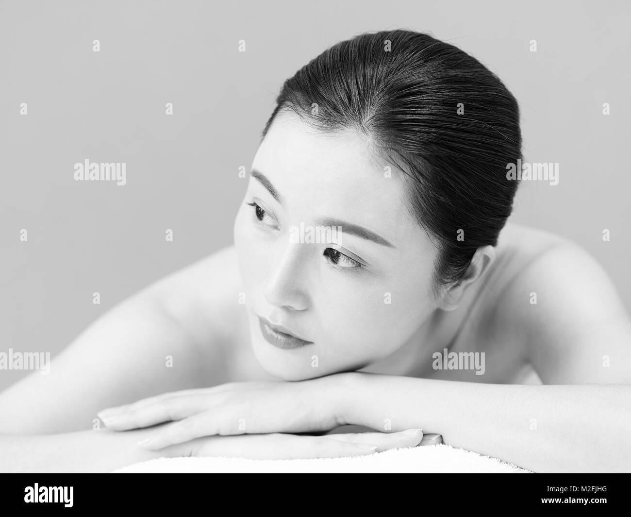 portrait of beautiful young asian woman, black and white, isolated on gray background. Stock Photo