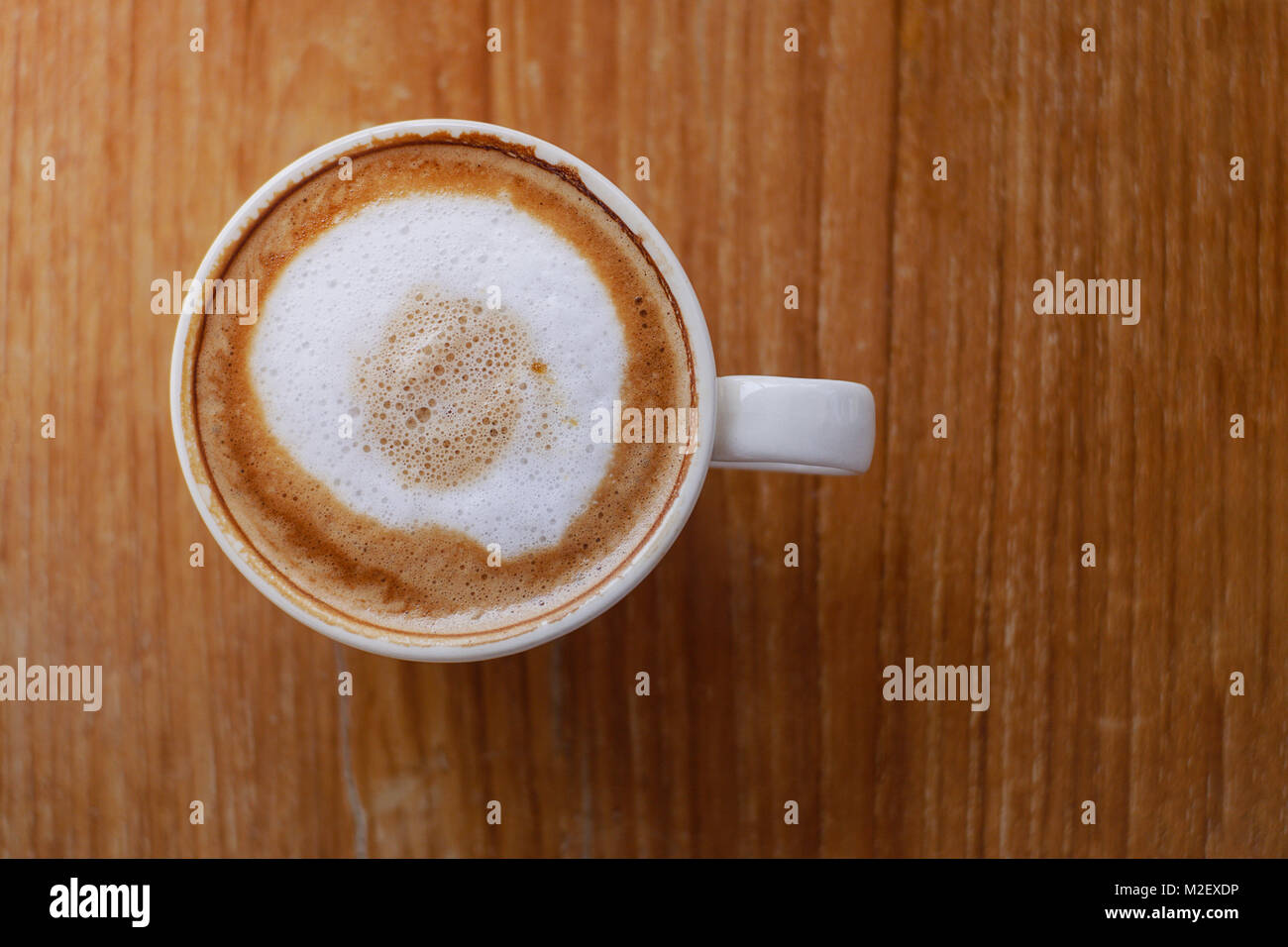 Hot coffee with latte art on table in coffee shop for background or cafe menu design Stock Photo