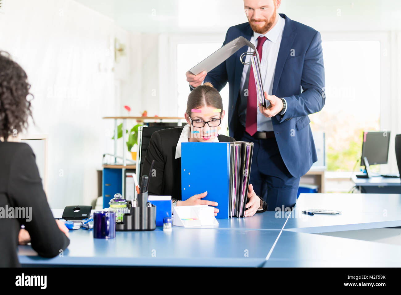 Desperate and stressed assistant at the office Stock Photo