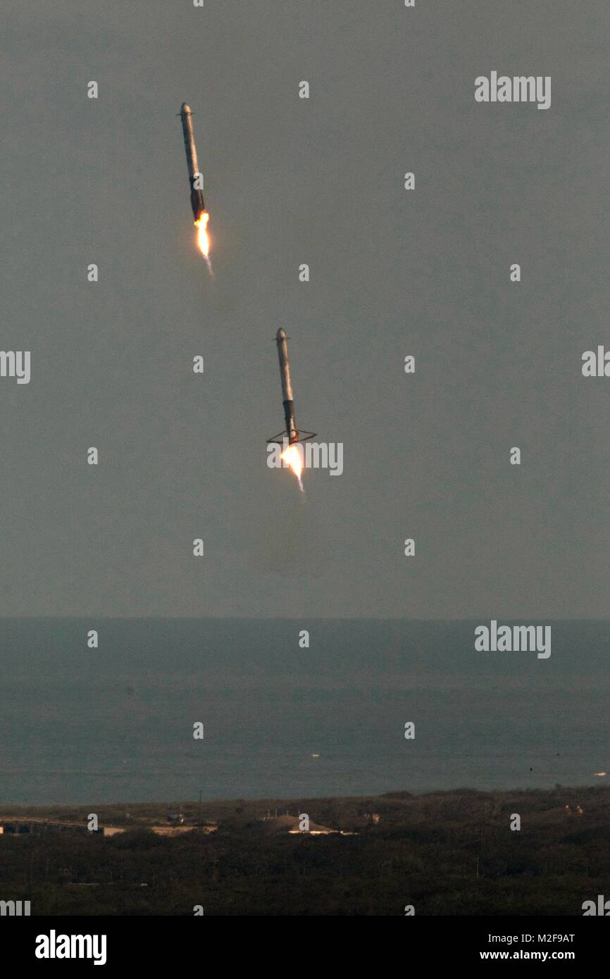 Cape Canaveral, Florida. February 6, 2018 .  SpaceX Falcon Heavy booster rockets descend to land after lifting a demonstration payload into space from Launch Complex 39A at Kennedy Space Center February 6, 2018 in Cape Canaveral, Florida. SpaceX successfully launched the world's most powerful rocket which will eventually carry a crew to Mars. Credit: Planetpix/Alamy Live News Stock Photo