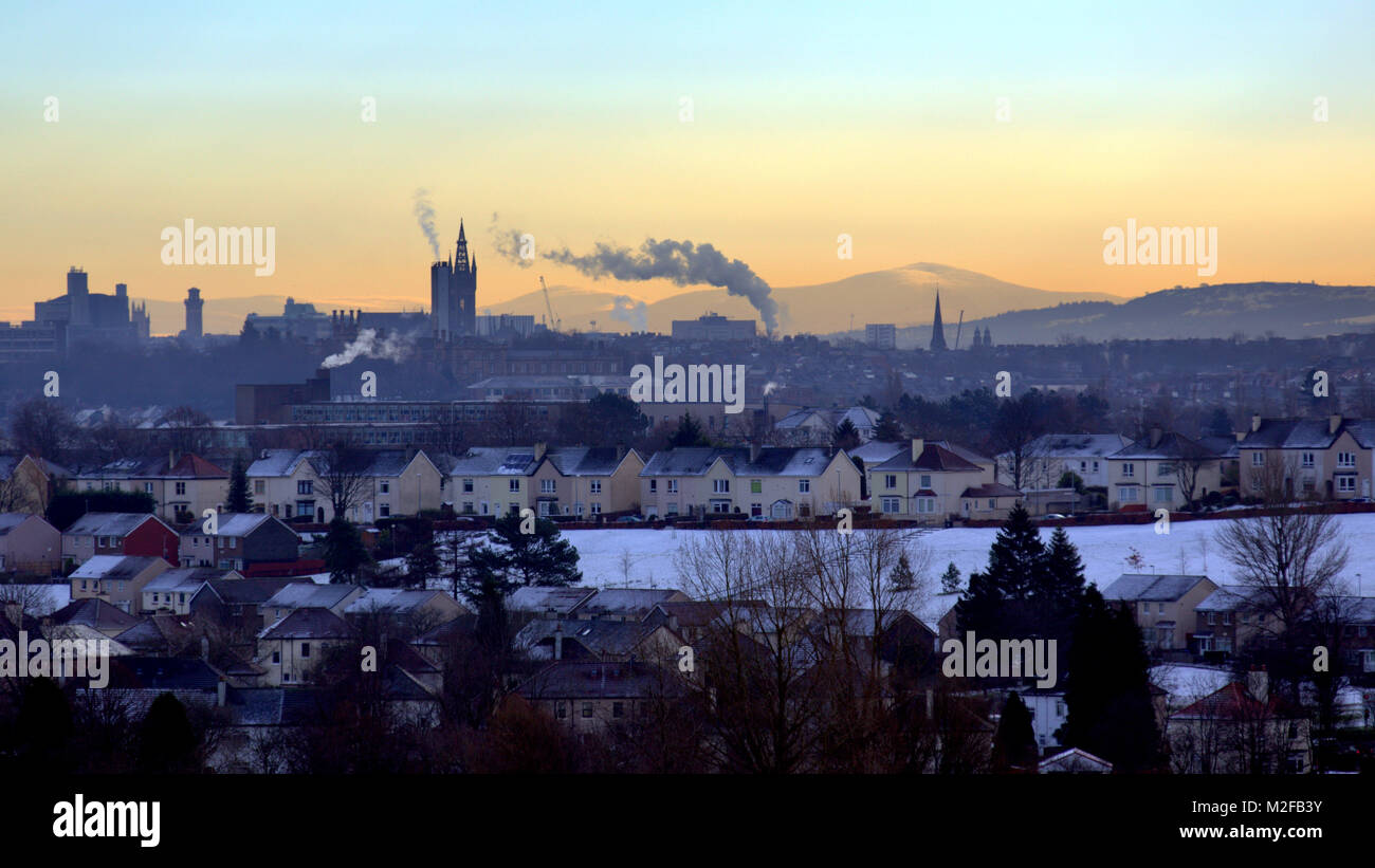 Glasgow, Scotland, UK 7th February. Snow in Glasgow knightswood gives way to ice as the UK freezes As the clock tower of Glasgow university and the spire of cottiers theatre silhouette against tinto hill and the beginnings if the border hills  . Gerard Ferry/Alamy news Stock Photo