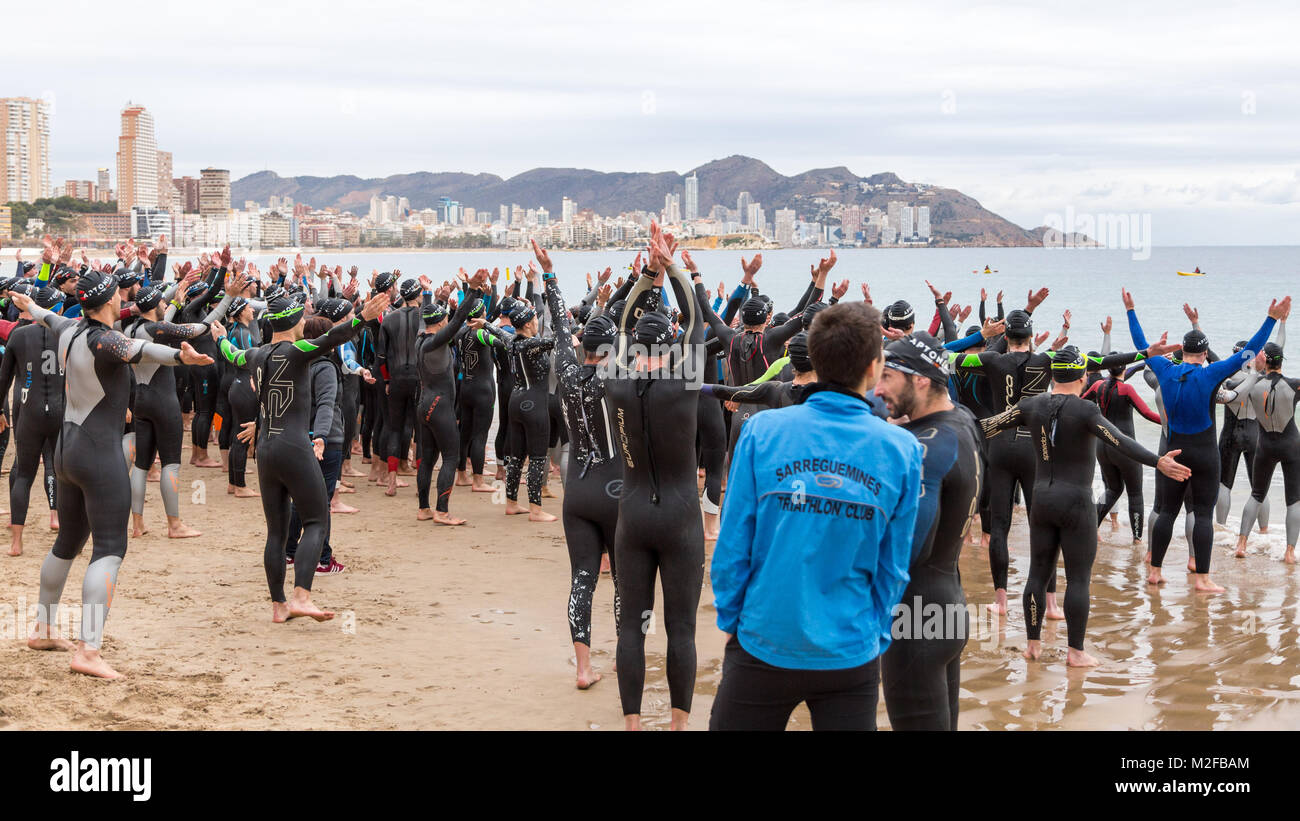 Benidorm, Costa Blanca, Spain, 7th February 2018. French sports retailer  Decathlon host a triathlon on Poniente Beach, swimming, cycling, running,  competing. Group of competitors, young men and women run across the sand