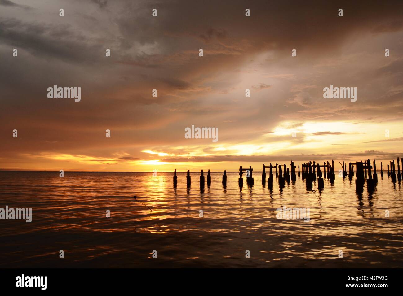 dilapidated wood pilings off the North Borneo Coast Stock Photo