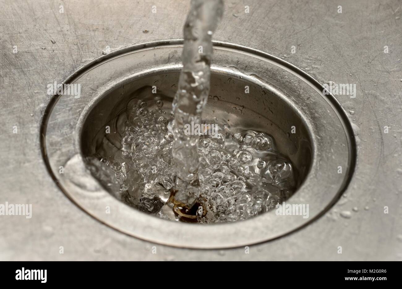 Water pouring into a plughole close up macro Stock Photo