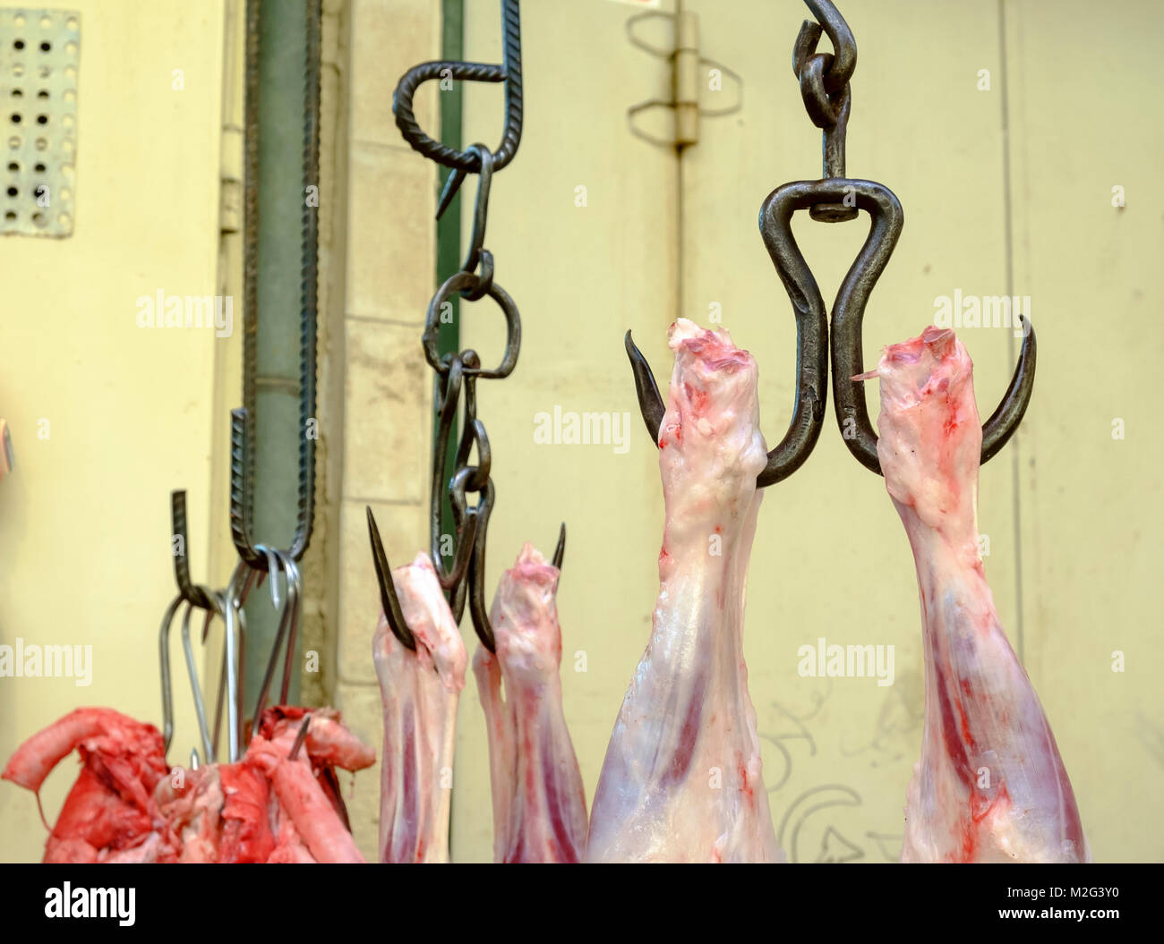 Fresh Meat hanging from a rack in a small family run Butcher shop. Photographed in Nazareth, Israel Stock Photo