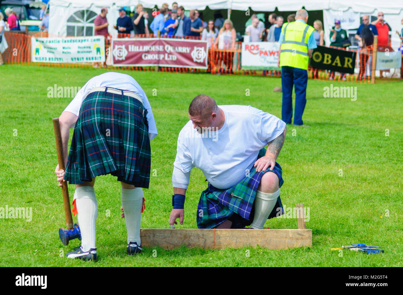 Male competitors preparing to compete in the heavy events at the Dundonald Highland Games, Ayrshire, which celebrates traditional Scottish culture Stock Photo