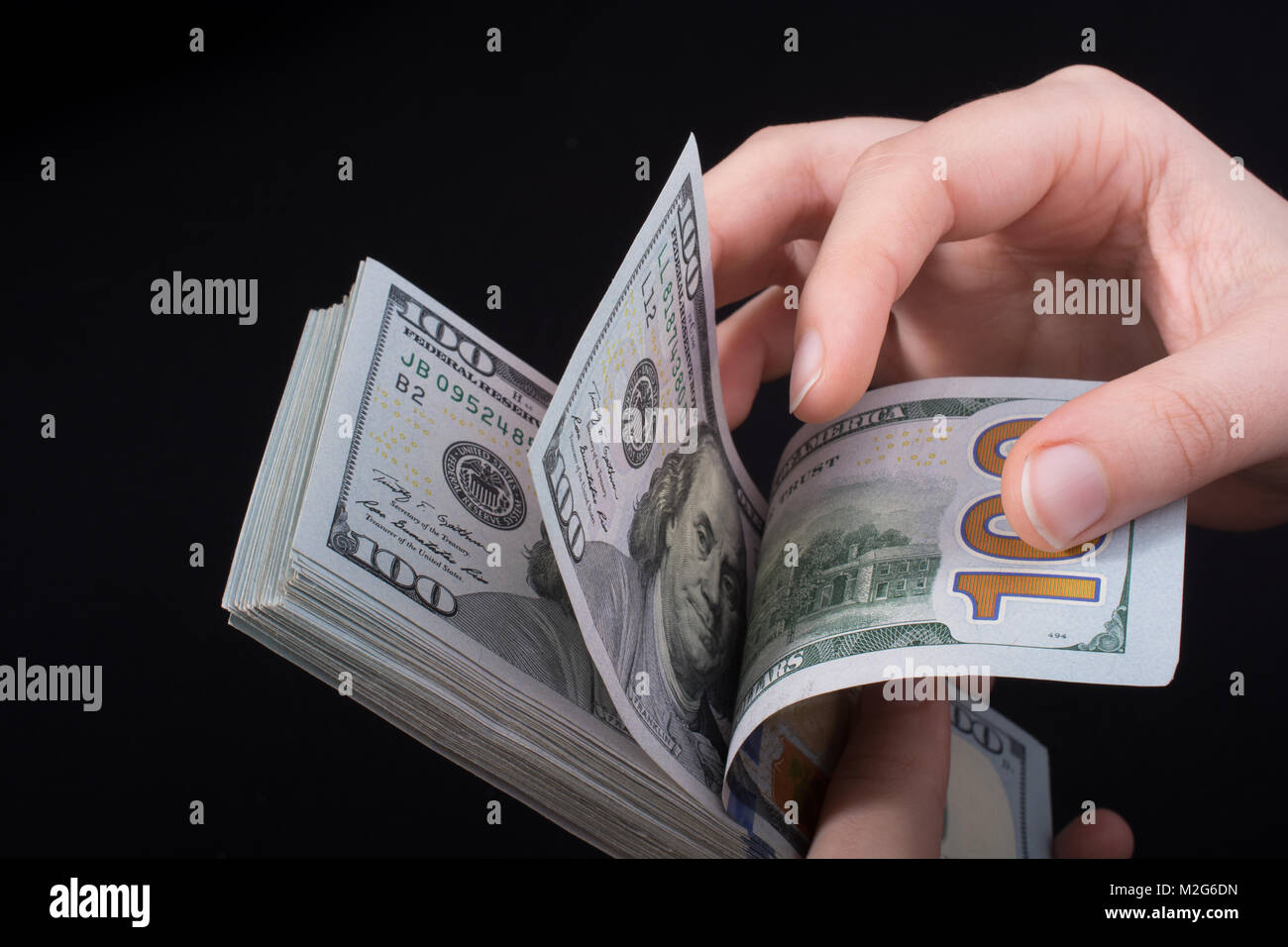 Hand holding American dollar banknotes isolated on white background ...