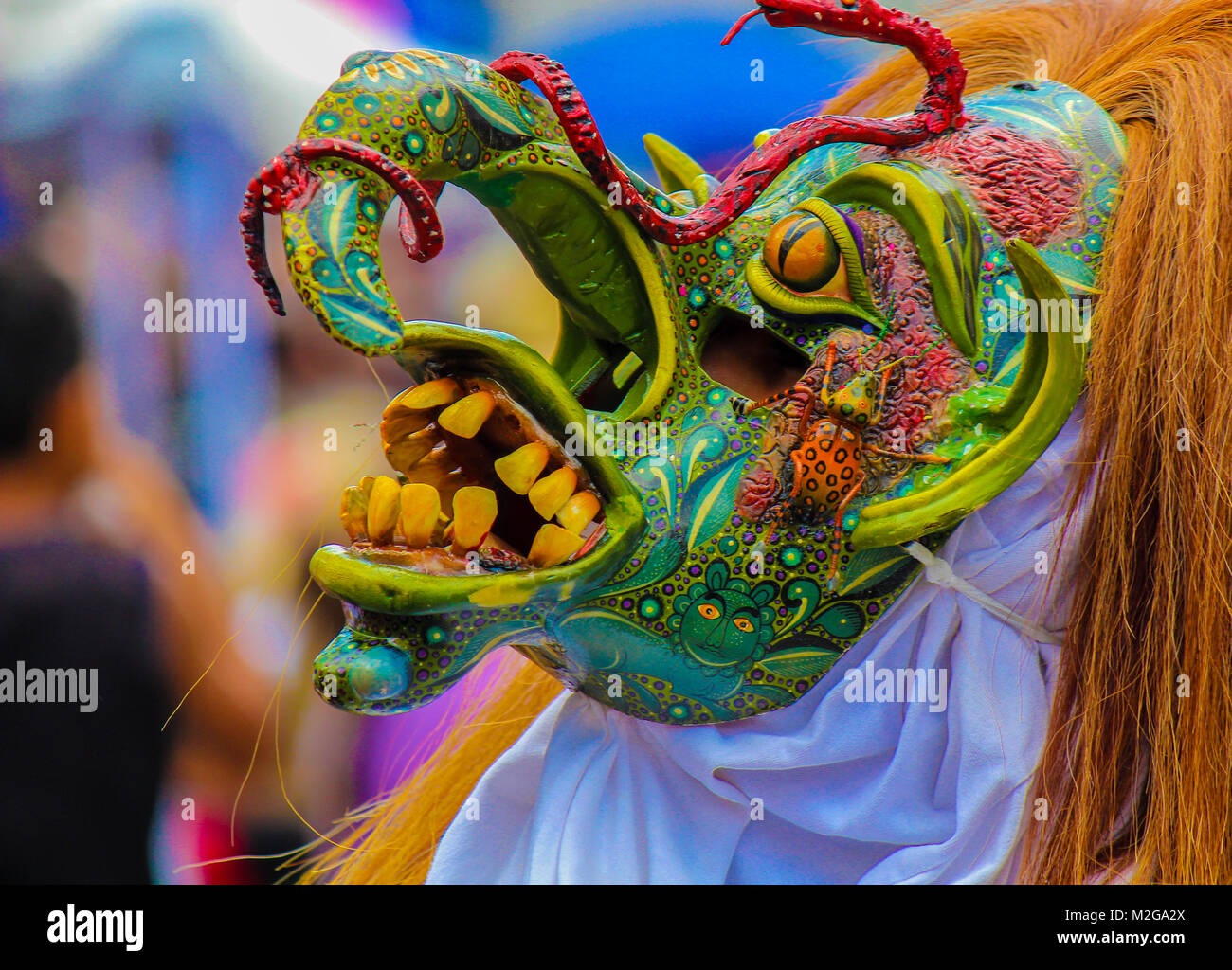terrifying green mask of warrior 'tastoan' in a traditional mexican carnival Stock Photo