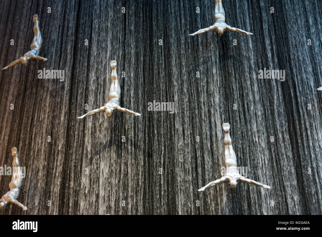 DUBAI, UNITED ARAB EMIRATES - FEBRUARY 5, 2018: Water wall in Dubai mall known as Human Waterfalls where the cascading water occupies the height of th Stock Photo