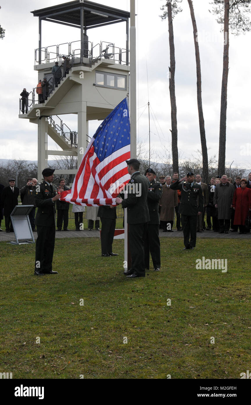 Soldiers from Headquarters and Headquarters Company, V Corps, lower the ...