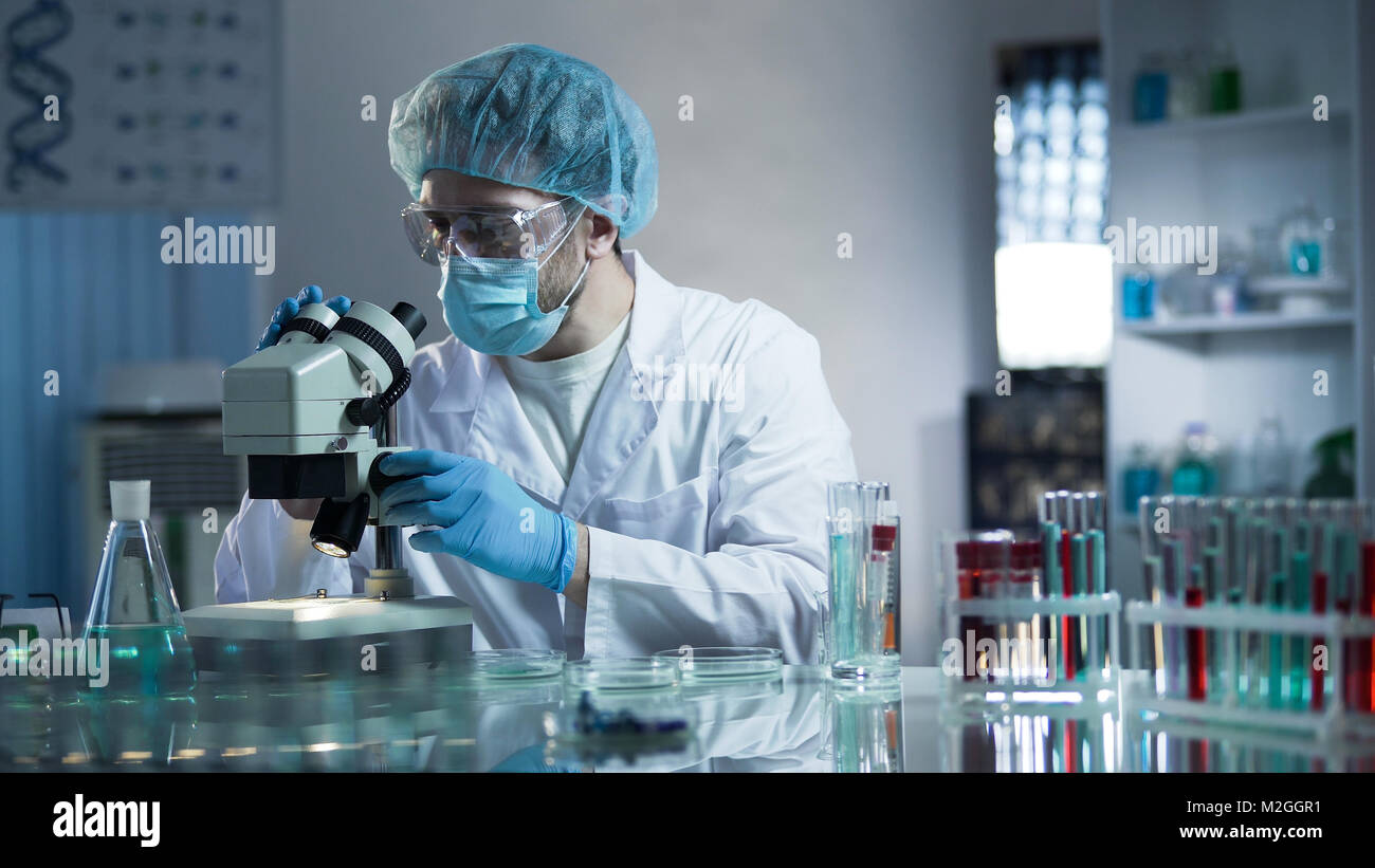 Lab assistant studying samples to detect pathologies, quality medical