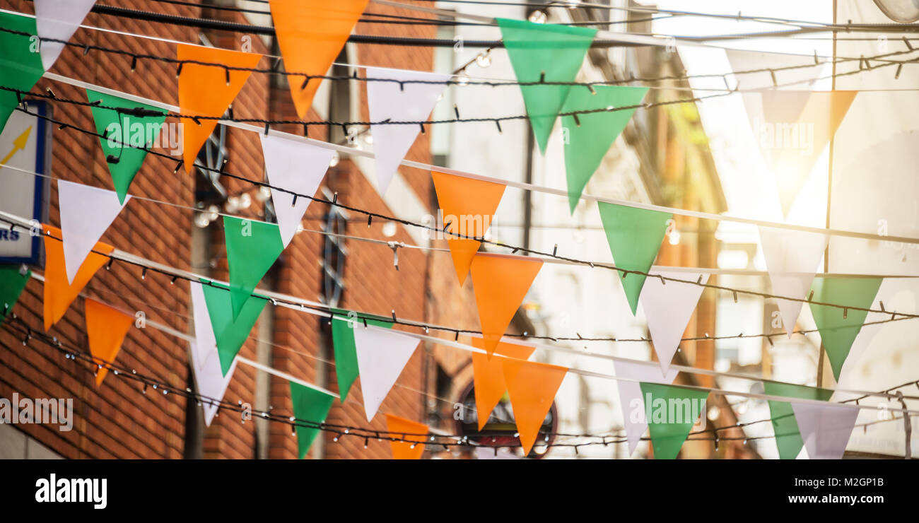Garland with irish flag colors in a street of Dublin, Ireland - Saint Patrick day celebration concept Stock Photo