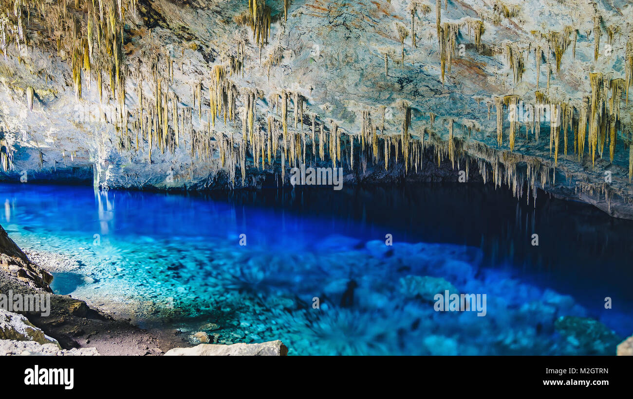 Bonito, Brazil - November 19, 2017: Inside the grotto of Lago Azul, a grotto with a lake with transparente vibrant blue water. Stalactites and stones. Stock Photo