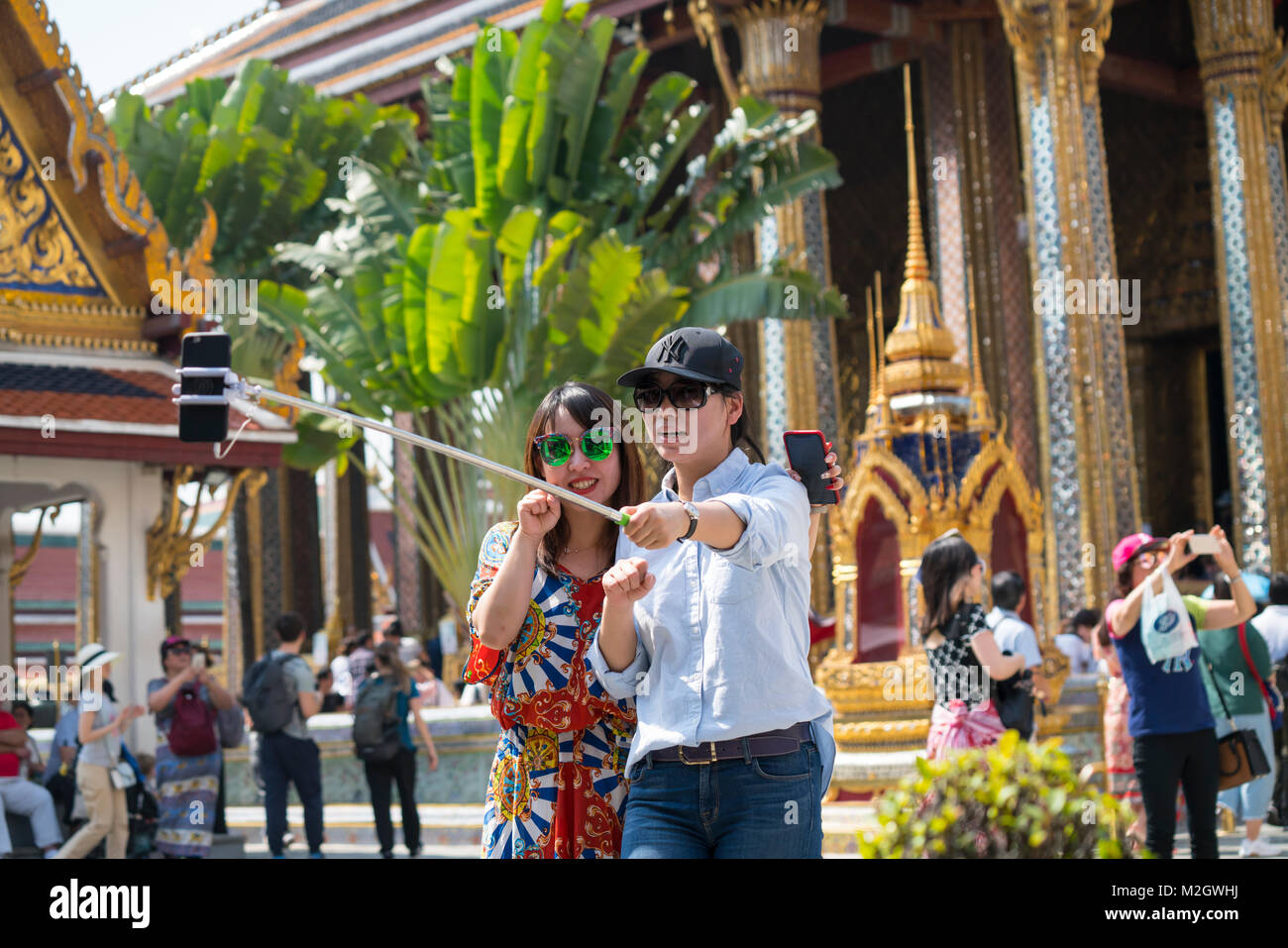 Tourists in Wat Phra Kaew and the great real palace in Bangkok Stock Photo