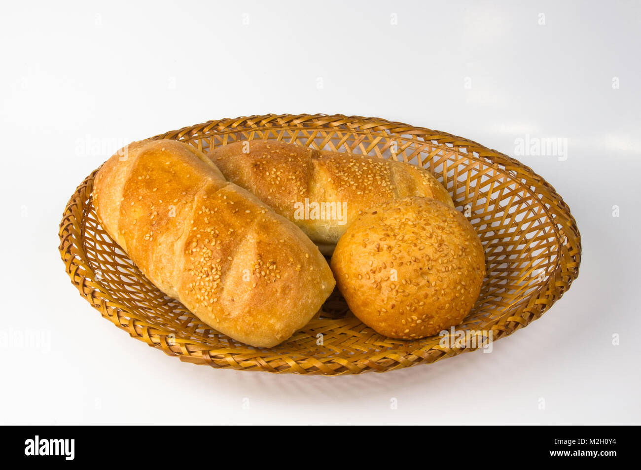 whole wheat breads and bun on a wicker plate Stock Photo - Alamy