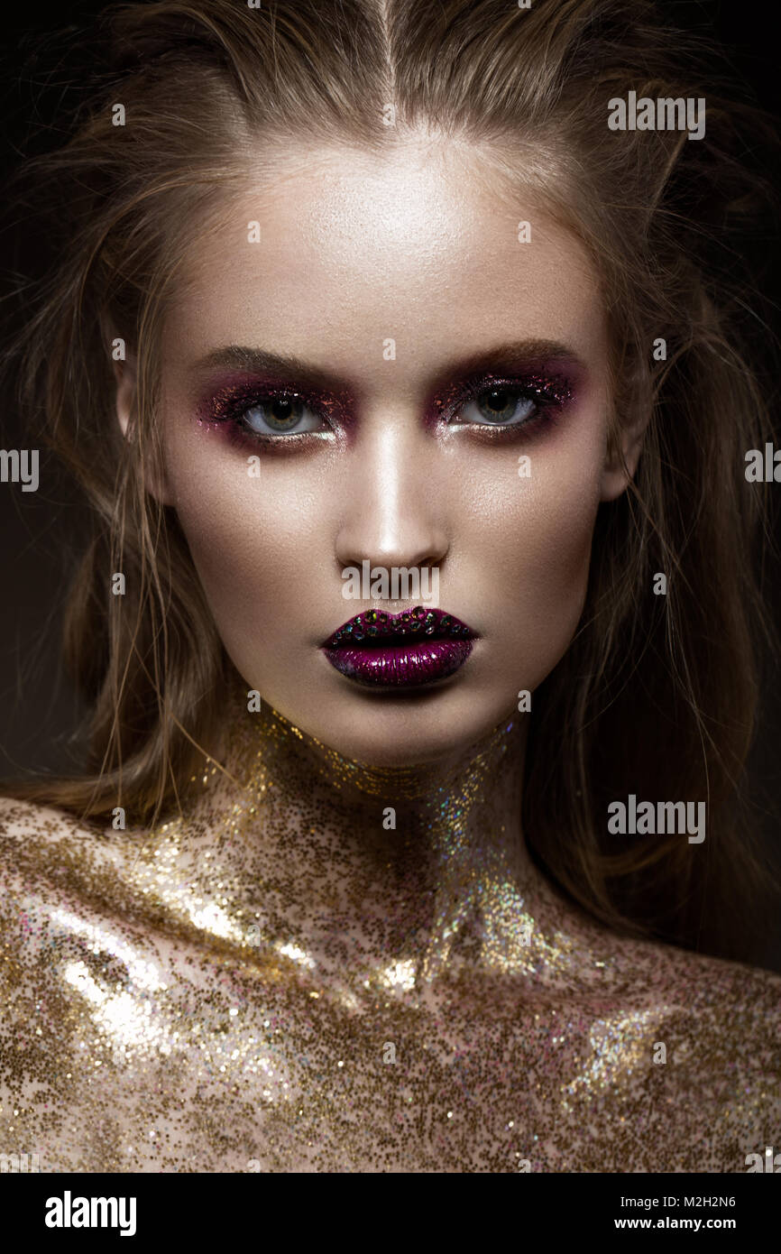 Beautiful girl with creative bright makeup with rhinestones . Beauty face. Stock Photo