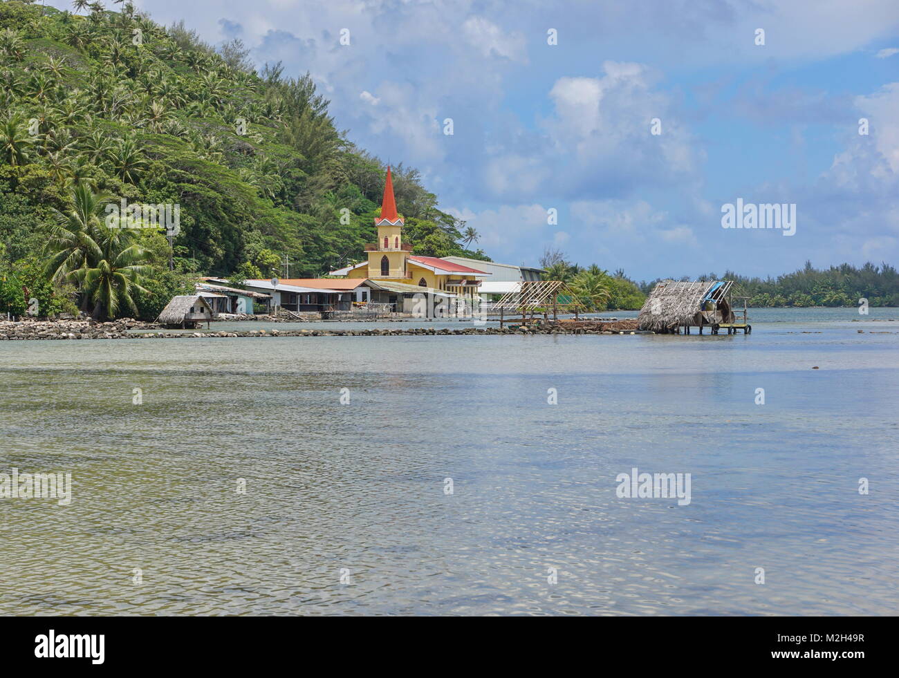 Huahine island church and fishing trap of Maeva village on the shore of the saltwater lake Fauna Nui, French Polynesia, south Pacific Stock Photo