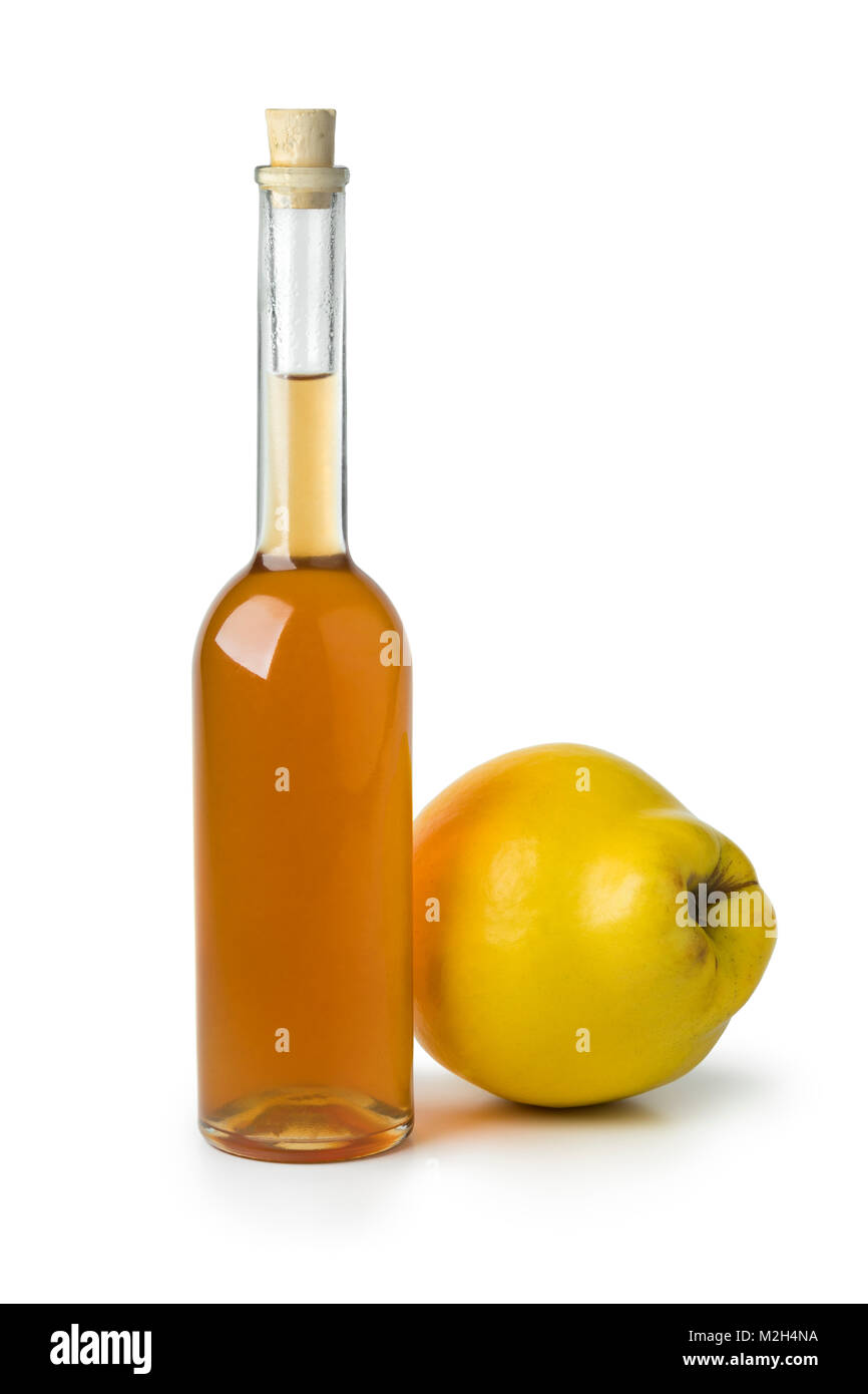 Glass bottle of homemade quince liqueur isolated on white background Stock Photo