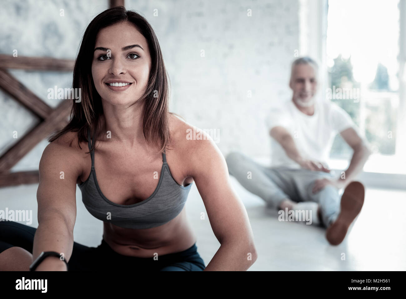 Beaming young lady getting excited over yoga session Stock Photo