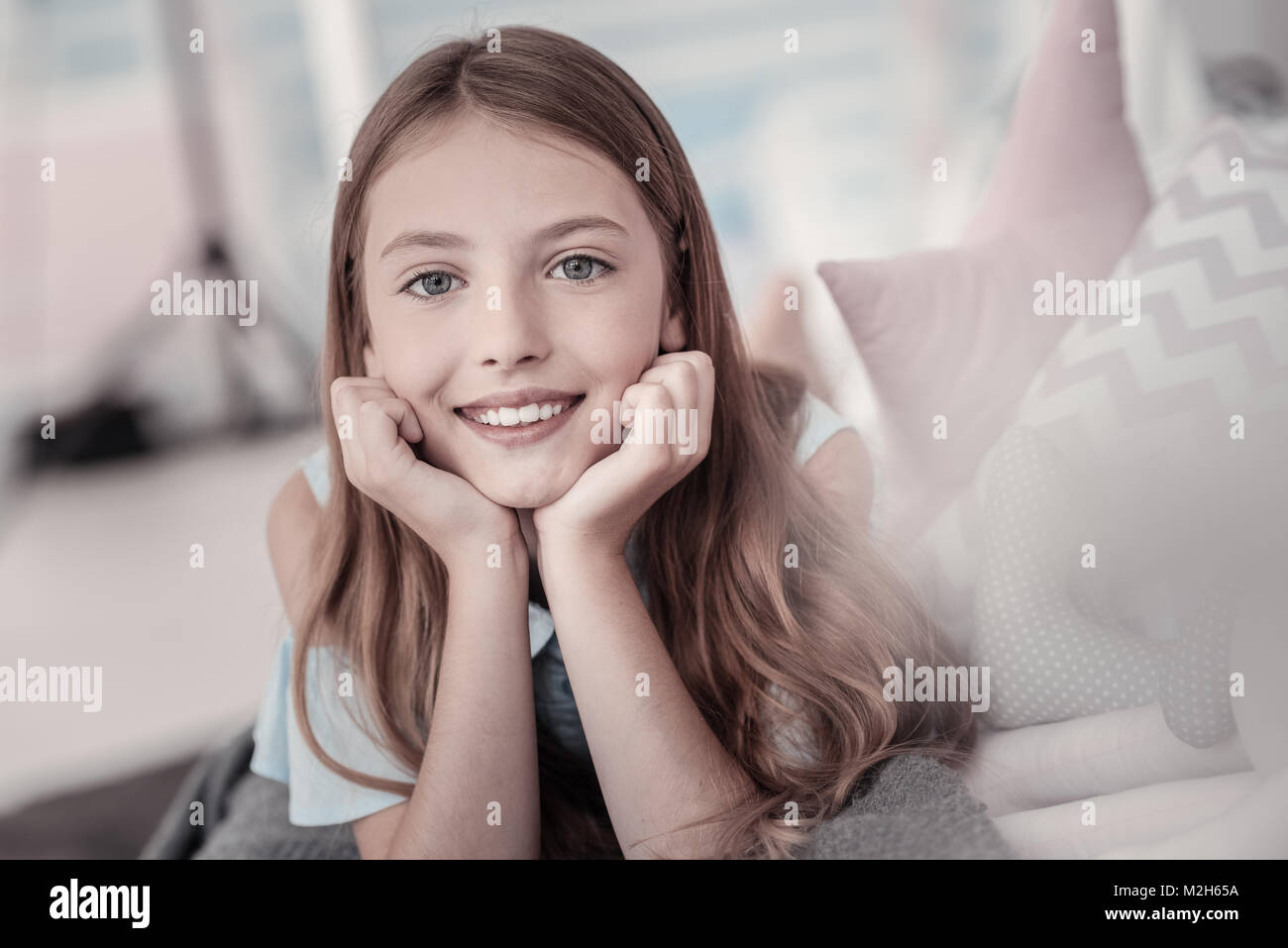 Beautiful smiling girl relaxing on the floor Stock Photo - Alamy