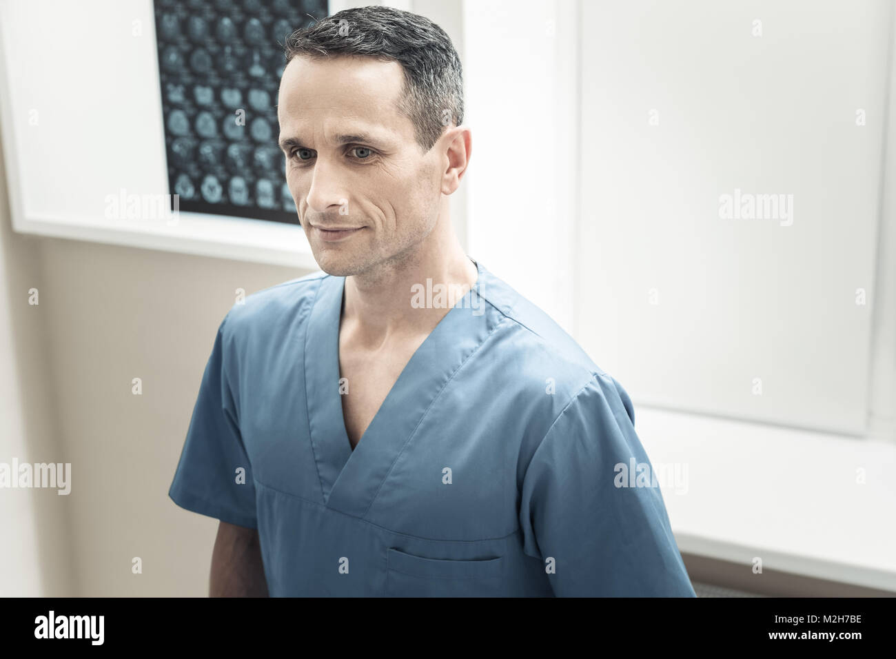 Delighted professional doctor being in a positive mood Stock Photo