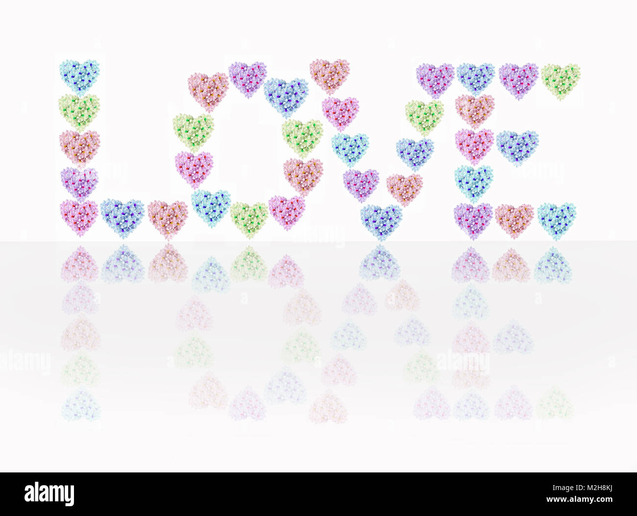 The inscription 'love' in heart shapes decorated with flowers on white background Stock Photo