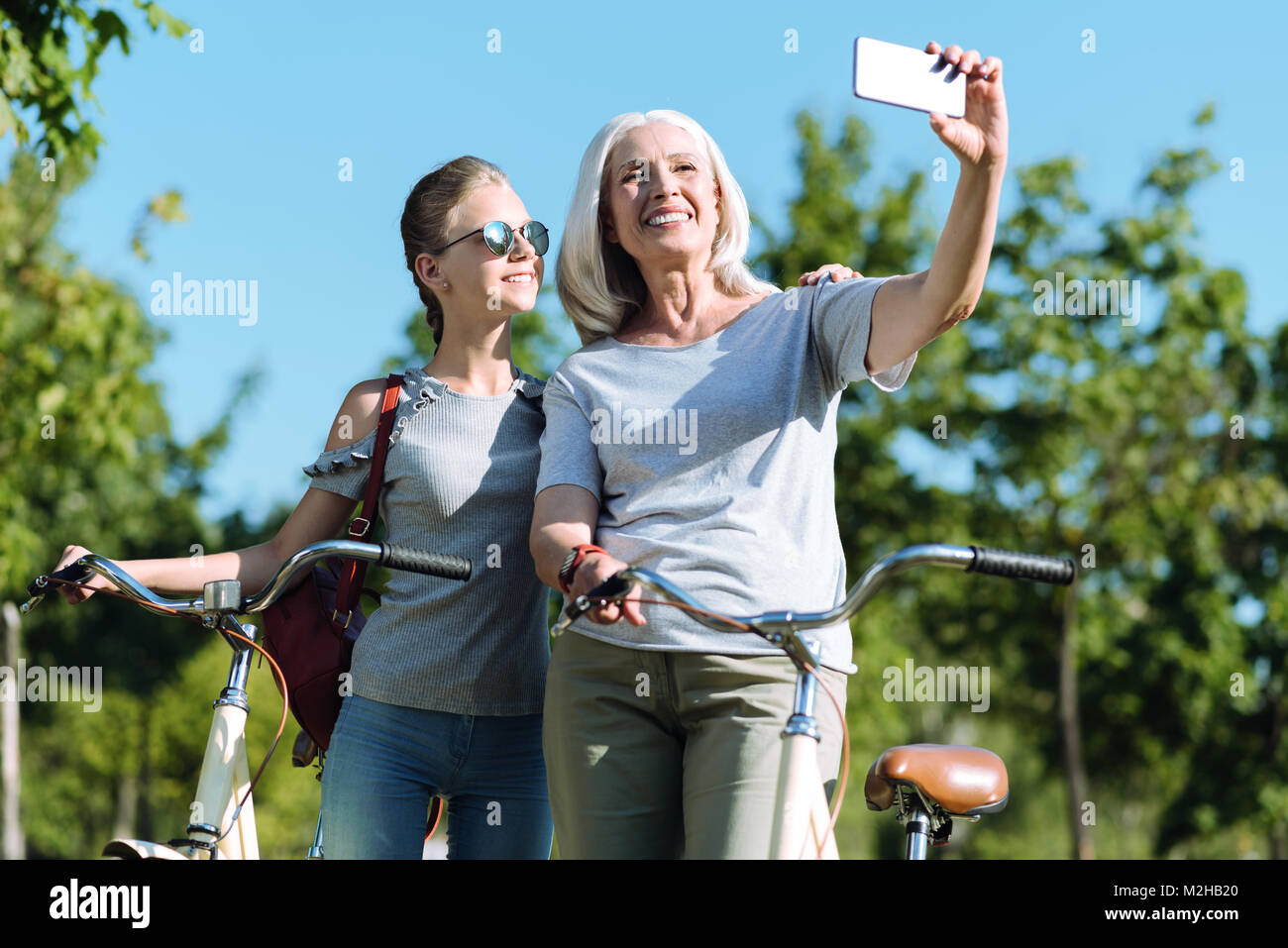 Delighted elderly woman taking a selfie Stock Photo - Alamy