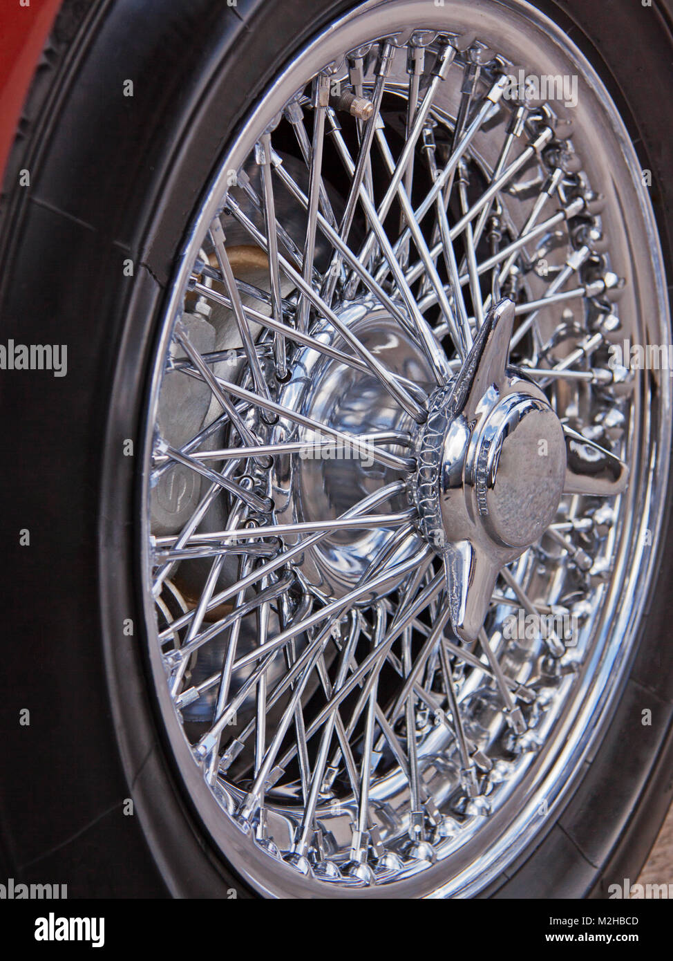 The highly polished chrome spokes and trim of a British sports car