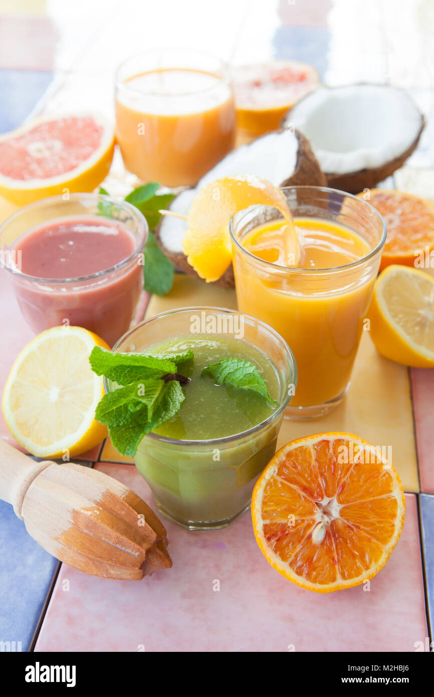 Variety of colorful smoothies and fresh fruits Stock Photo