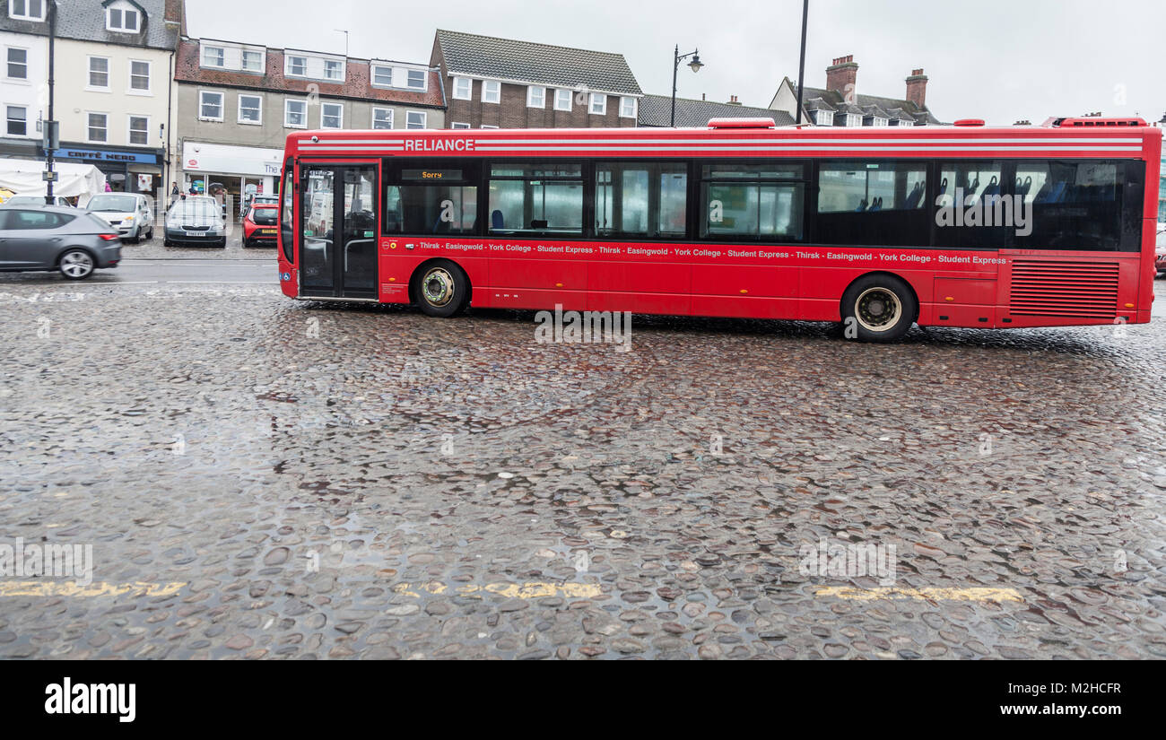 Large red Reliance bus parked in Thirsk market place, England, UK Stock Photo