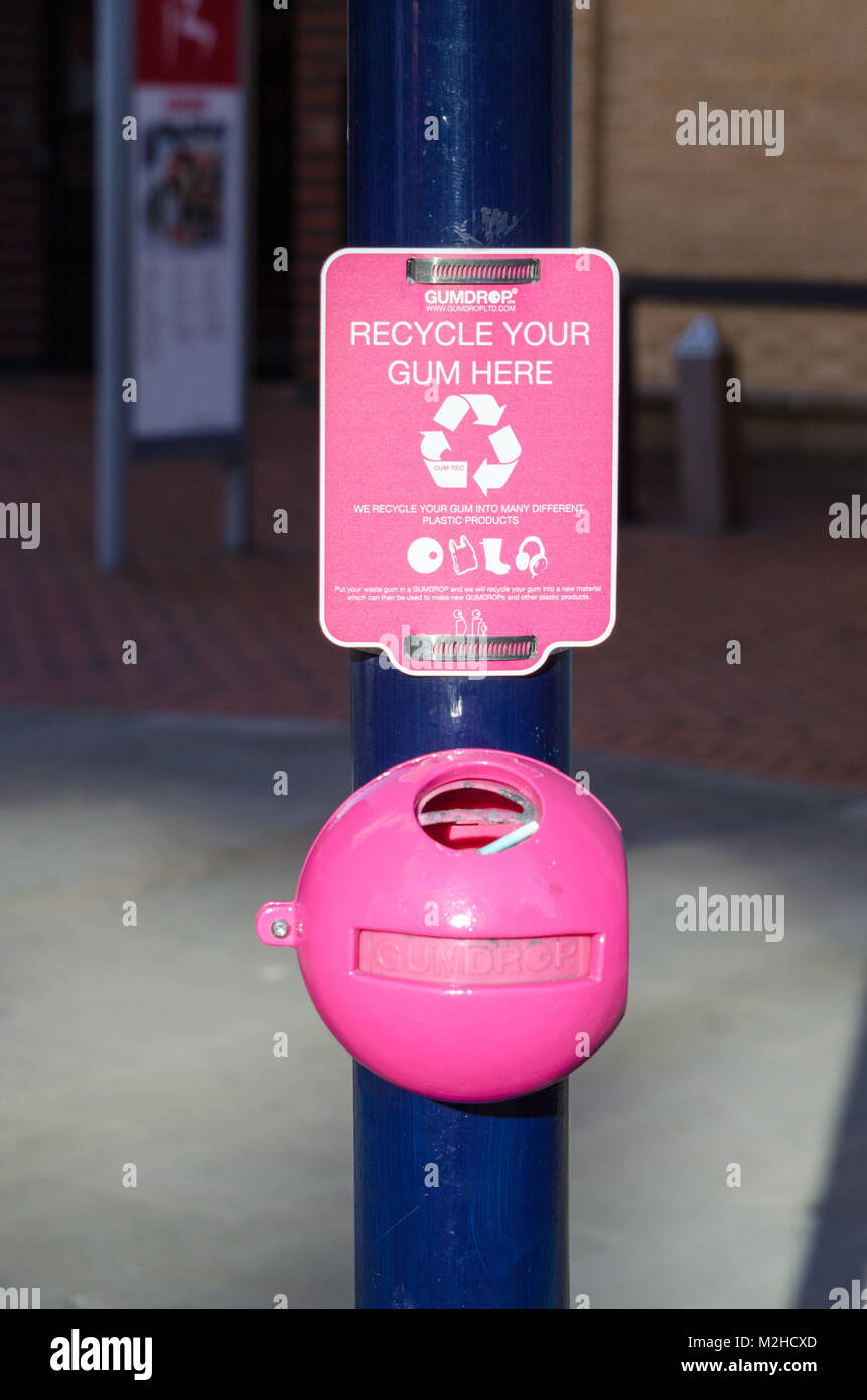 Gumdrop environmentally friendly bright pink container for recycling used chewing gum attached to a post in Brindley Place, Birmingham, UK Stock Photo