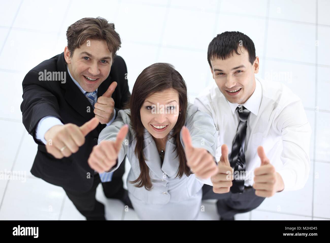 successful business team showing thumbs up Stock Photo - Alamy