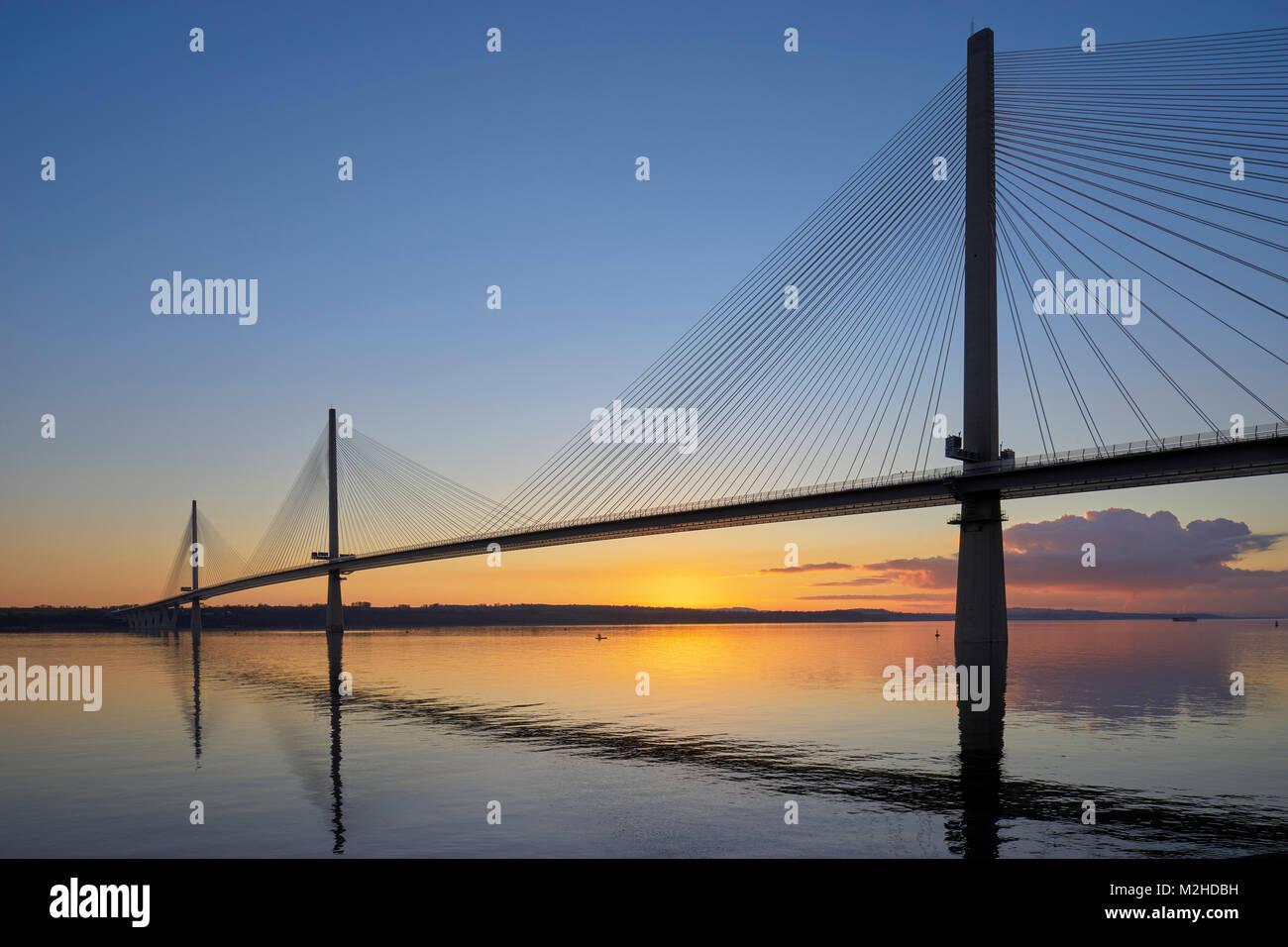 Queensferry Crossing Bridge from North Queensferry, Fife, Scotland at sunset with reflection Stock Photo