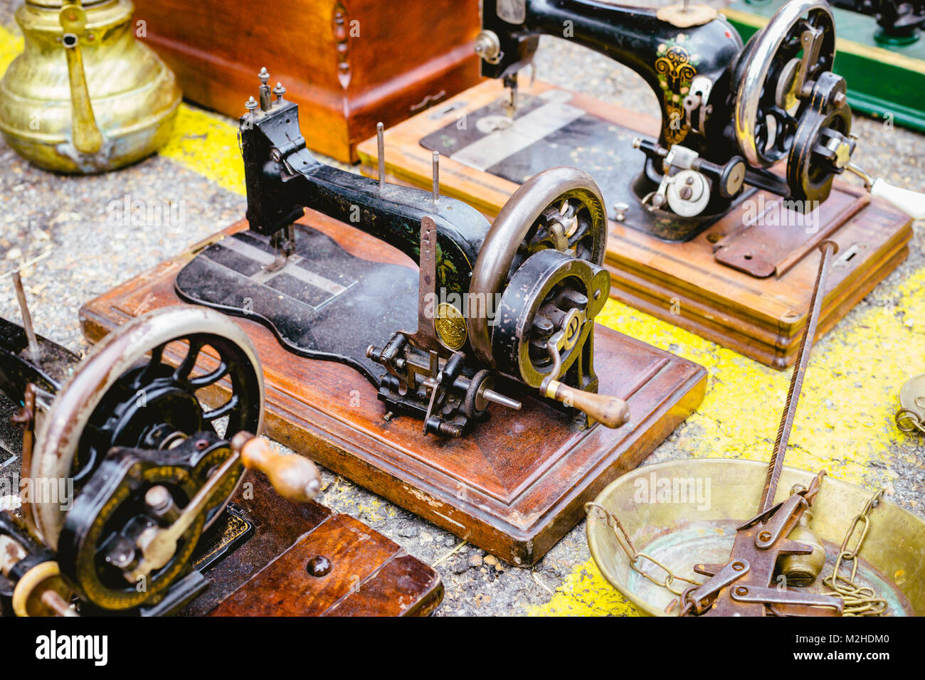 Black retro sewing machines in outdoor market Stock Photo Alamy