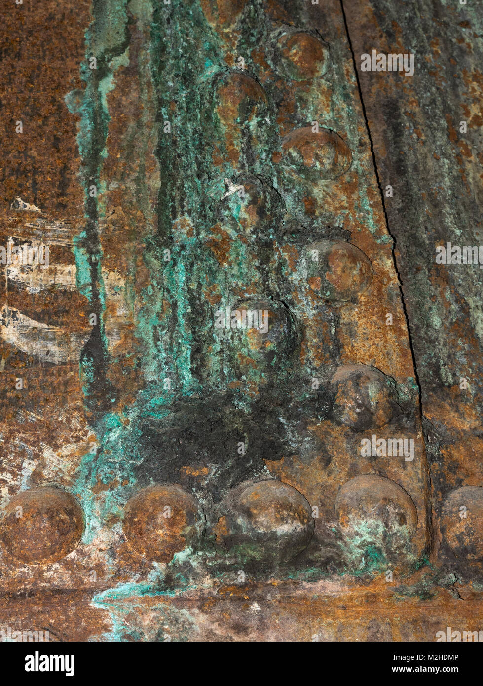 Rusted Copper Stains A Plate With Green Streaks Around Domed Bolts Stock Photo Alamy