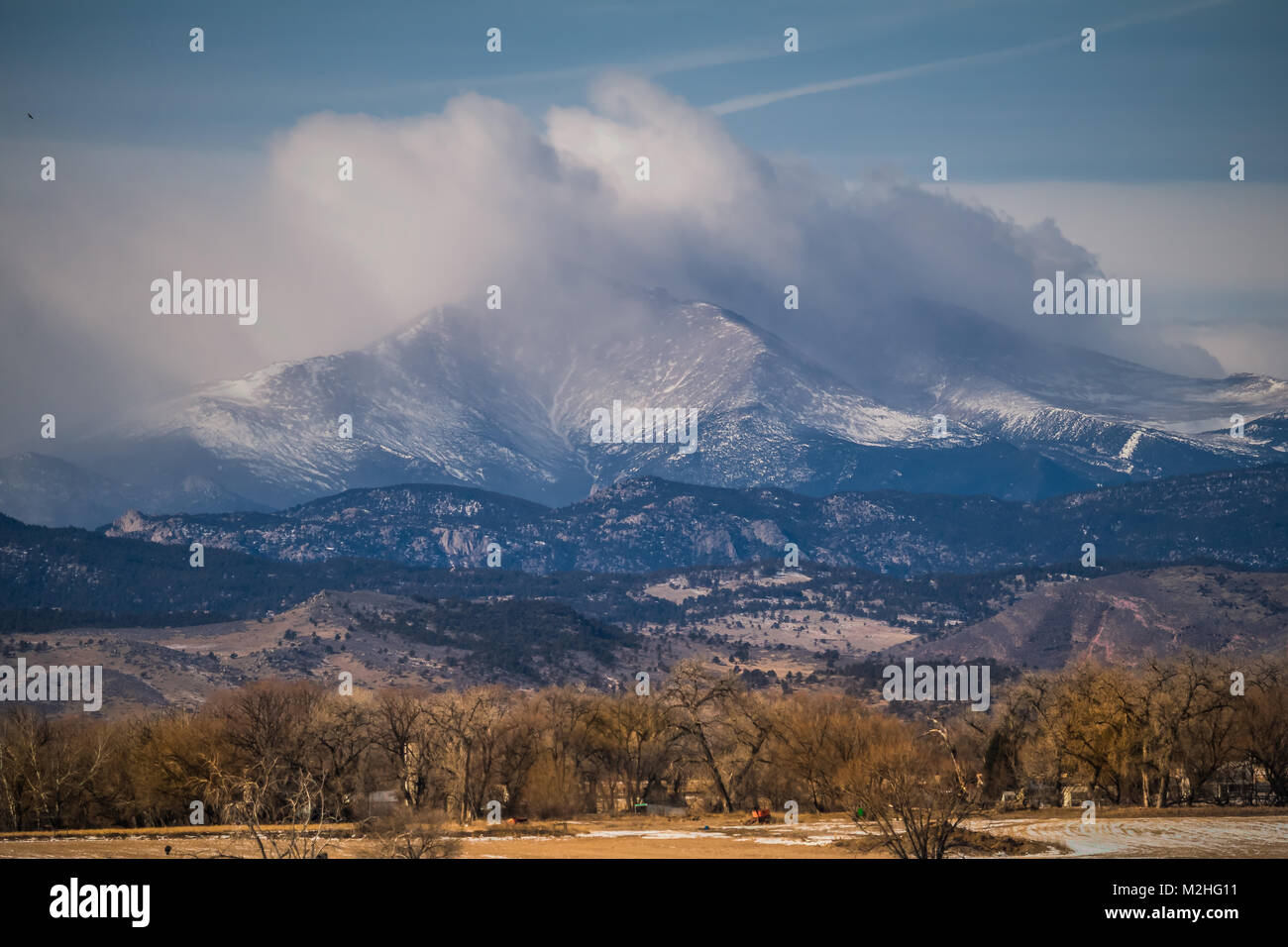 Dramatic view of Longs Peak of the Rocky Mountains, Colorado; the summit is covered with clouds; USA Stock Photo