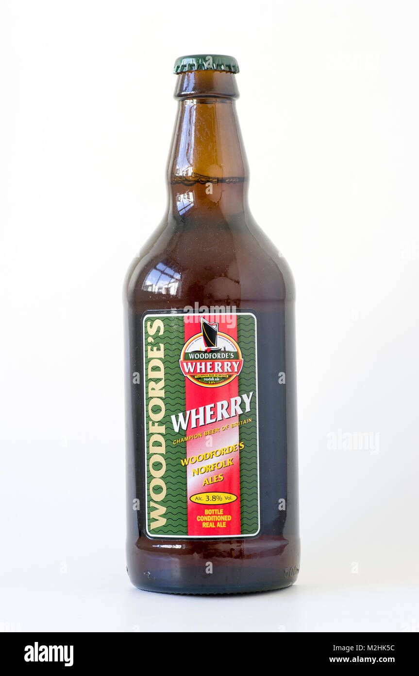 A bottle of real ale from East Anglian Woodforde's  Brewery - WHERRY depicting an old sailing barge in UK Stock Photo