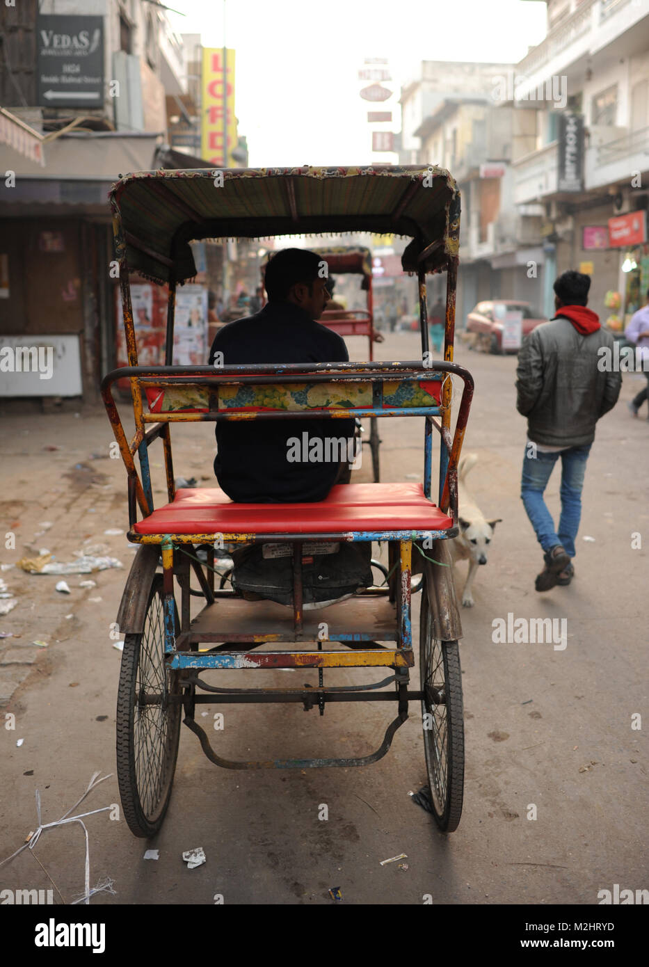 A rickshaw driver waits for business early in the morning in Paharganj, in Delhi India Stock Photo