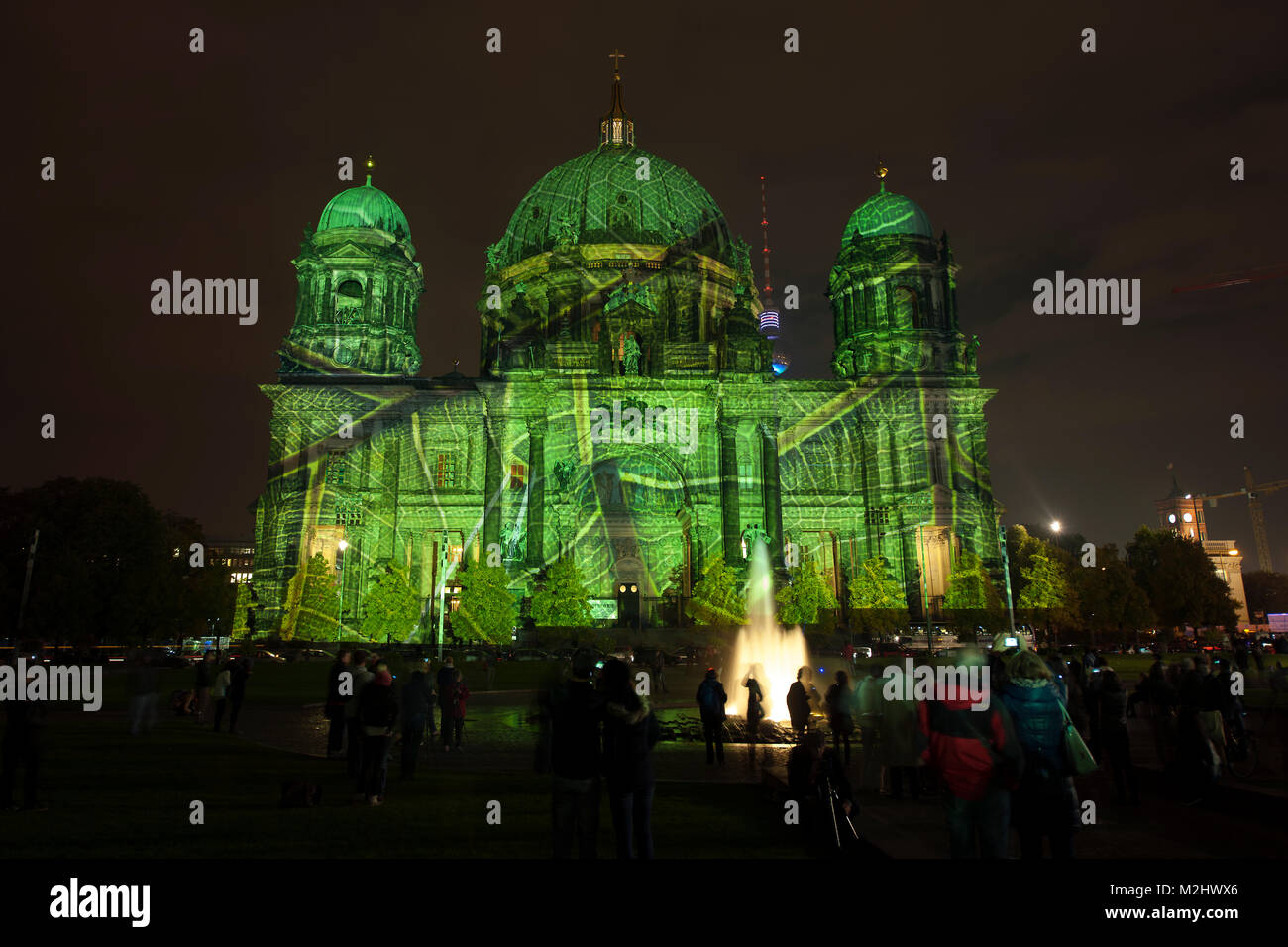 9th Festival of Light in Berlin had the official opening in PotsdamPlatz with some German celebrities. The annual Festival of Lights in Berlin where dozens of buildings are illuminated in fantastic colors and by video projection and thousands of visitors. Stock Photo